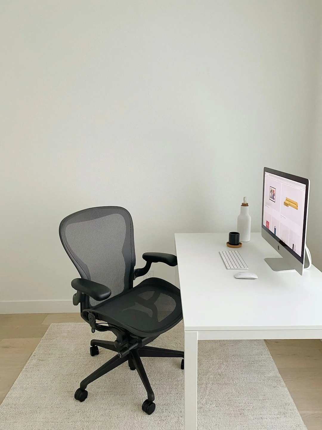 A clean desk arrangement with dual monitors, a keyboard, a mouse, and a notebook designed for productivity.