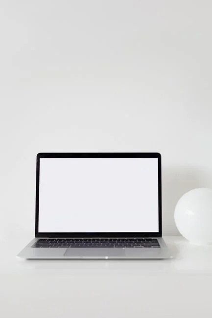Stylish and efficient workspace with multiple monitors, laptop, and smartphone, showcasing a web design project.
